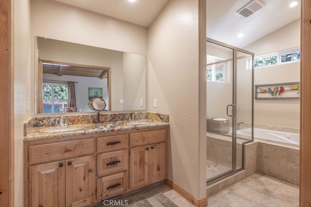 bathroom featuring double vanity, visible vents, a stall shower, and a sink