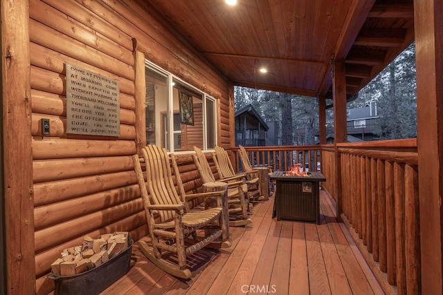 wooden deck with an outdoor fire pit