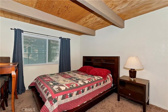 carpeted bedroom featuring beamed ceiling and wooden ceiling