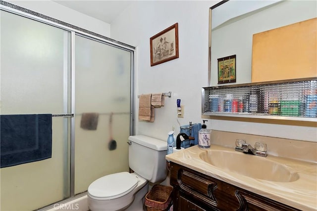 full bathroom with toilet, vanity, and a shower stall