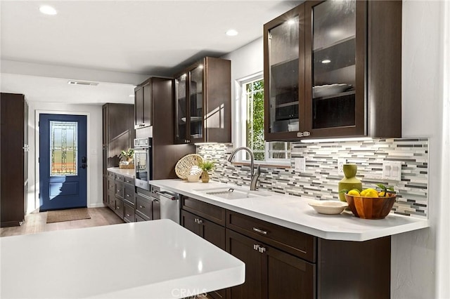 5222 Foster Rd, Paradise, CA 95969 - kitchen featuring light countertops, a sink, dark brown cabinets, and tasteful backsplash