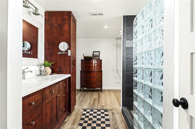 5222 Foster Rd, Paradise, CA 95969 - bathroom with visible vents, wood finished floors, tiled shower, and vanity