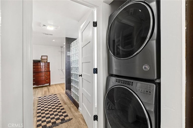 5222 Foster Rd, Paradise, CA 95969 - clothes washing area featuring laundry area, visible vents, stacked washer / dryer, light wood-style floors, and baseboards