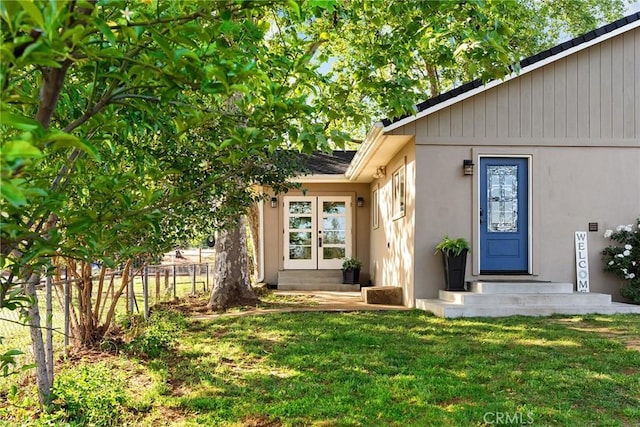 5222 Foster Rd, Paradise, CA 95969 - entrance to property featuring french doors, fence, stucco siding, and a lawn