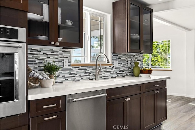 5222 Foster Rd, Paradise, CA 95969 - bar with a sink, light wood finished floors, stainless steel appliances, baseboards, and decorative backsplash
