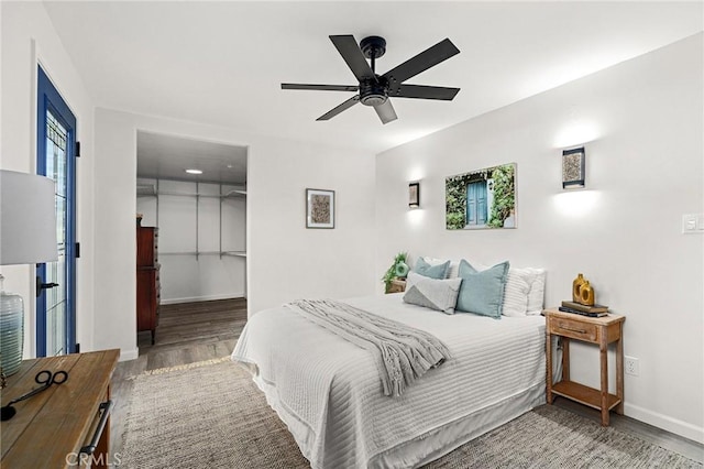 5222 Foster Rd, Paradise, CA 95969 - bedroom featuring baseboards, a ceiling fan, wood finished floors, and a walk in closet