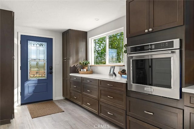 5222 Foster Rd, Paradise, CA 95969 - kitchen featuring dark brown cabinetry, light wood-type flooring, light countertops, baseboards, and stainless steel oven