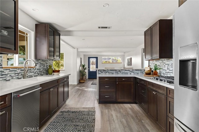 5222 Foster Rd, Paradise, CA 95969 - kitchen featuring a peninsula, light countertops, a sink, light wood-style flooring, and appliances with stainless steel finishes