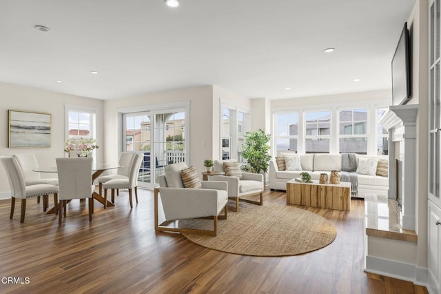 living room featuring recessed lighting, wood finished floors, and baseboards
