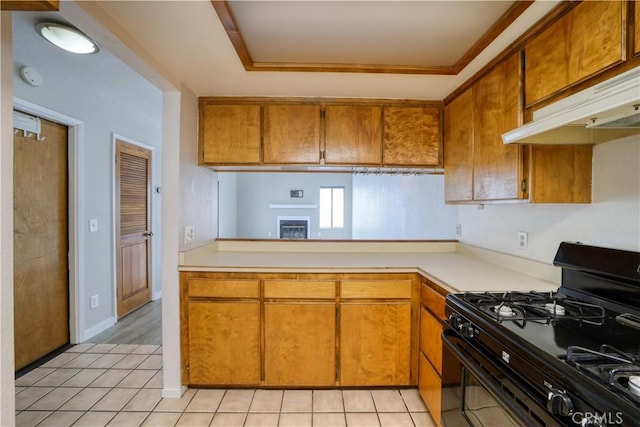10710 El Camino Real Unit 26, Atascadero, CA 93422 - kitchen featuring black range with gas stovetop, light countertops, brown cabinetry, and under cabinet range hood