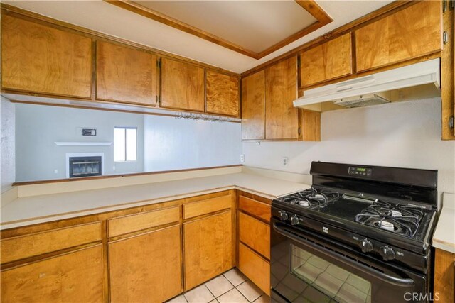 10710 El Camino Real Unit 26, Atascadero, CA 93422 - kitchen featuring brown cabinetry, light countertops, gas stove, and under cabinet range hood