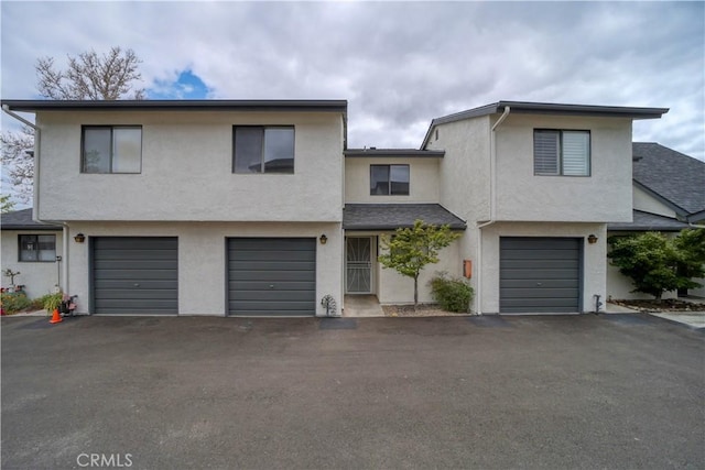 10710 El Camino Real Unit 26, Atascadero, CA 93422 - townhome / multi-family property with a garage, stucco siding, and driveway