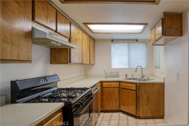 10710 El Camino Real Unit 26, Atascadero, CA 93422 - kitchen featuring stainless steel dishwasher, a sink, under cabinet range hood, black range with gas cooktop, and brown cabinetry