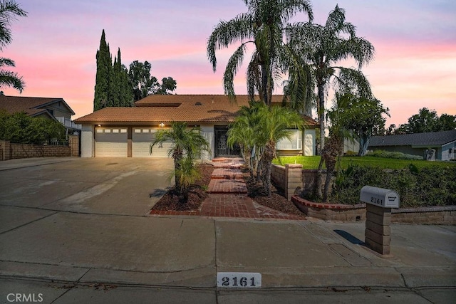 2161 Stonefield Pl, Riverside, CA 92506 - ranch-style house featuring concrete driveway, stucco siding, a tile roof, and a garage