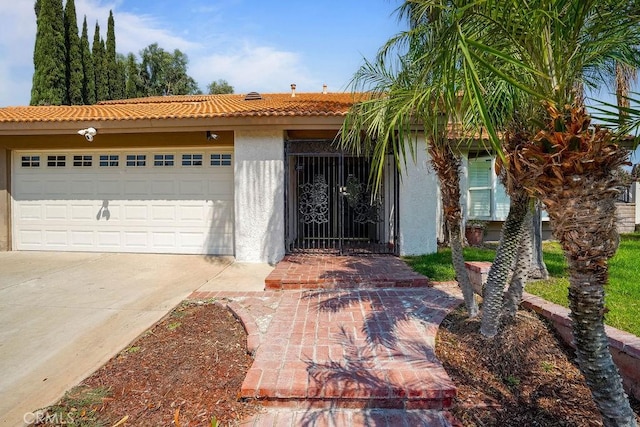 2161 Stonefield Pl, Riverside, CA 92506 - view of front of home with a garage, stucco siding, concrete driveway, and a tiled roof