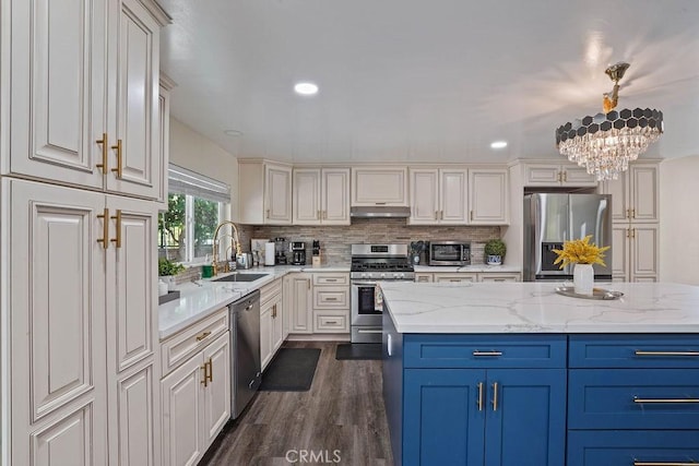 2161 Stonefield Pl, Riverside, CA 92506 - kitchen with dark wood-style flooring, blue cabinets, a sink, under cabinet range hood, and stainless steel appliances