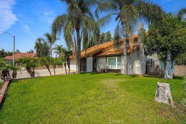 2161 Stonefield Pl, Riverside, CA 92506 - view of front of home with fence, a garage, stucco siding, a front yard, and a tiled roof