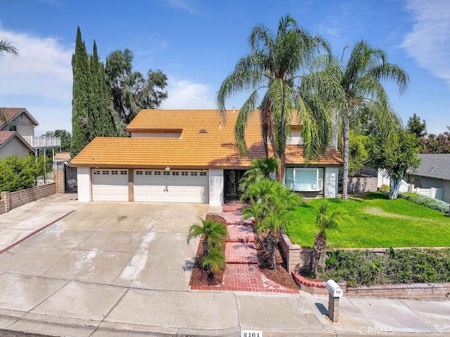 2161 Stonefield Pl, Riverside, CA 92506 - view of front of property with an attached garage, a front lawn, stucco siding, concrete driveway, and a tiled roof