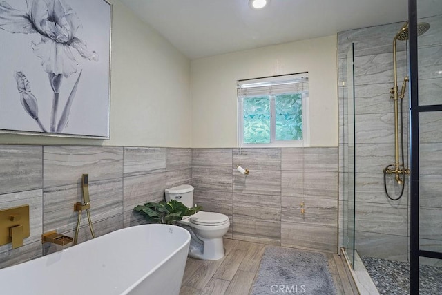 2161 Stonefield Pl, Riverside, CA 92506 - bathroom with wainscoting, a tile shower, toilet, tile walls, and a soaking tub