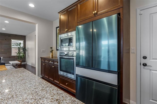 54 Revell Cir, Buena Park, CA 90620 - kitchen with stainless steel appliances, light stone counters, baseboards, and recessed lighting