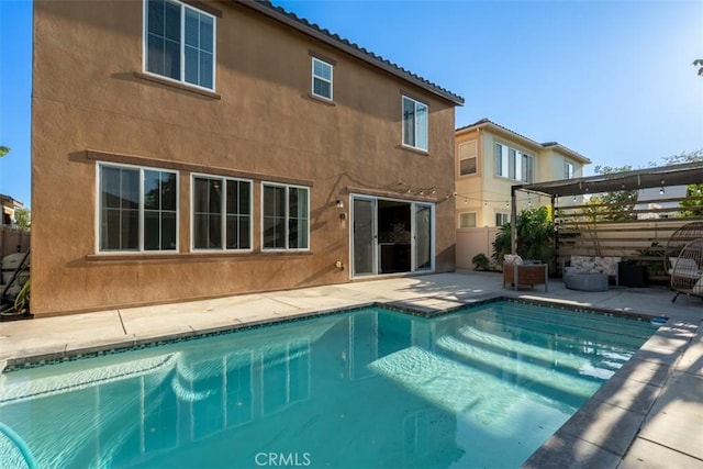 54 Revell Cir, Buena Park, CA 90620 - back of house with stucco siding, a patio area, an outdoor pool, and fence