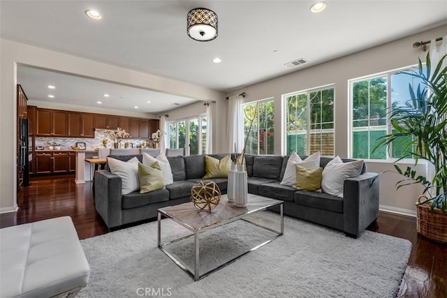 54 Revell Cir, Buena Park, CA 90620 - living area with healthy amount of natural light, recessed lighting, dark wood-style floors, and baseboards