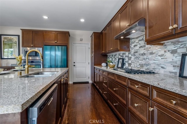 54 Revell Cir, Buena Park, CA 90620 - kitchen featuring stainless steel appliances, under cabinet range hood, light stone counters, dark wood finished floors, and a sink