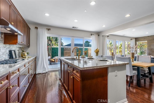 54 Revell Cir, Buena Park, CA 90620 - kitchen featuring appliances with stainless steel finishes, under cabinet range hood, dark wood-type flooring, plenty of natural light, and recessed lighting