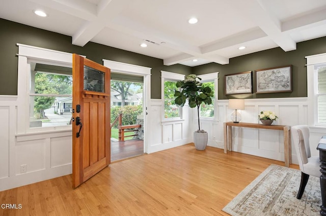 doorway to outside featuring coffered ceiling and a decorative wall