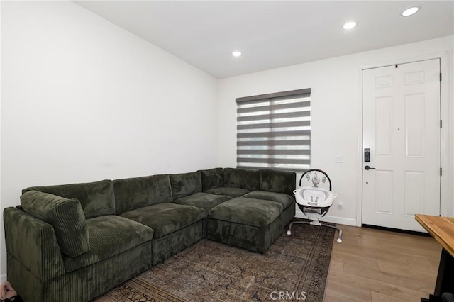 living room featuring wood finished floors, recessed lighting, and baseboards