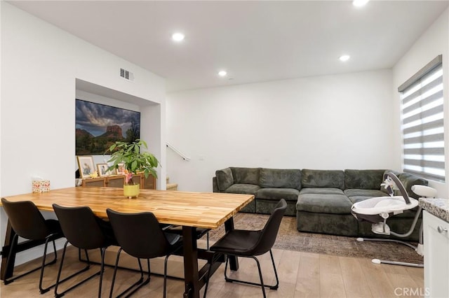 interior space with light wood finished floors, recessed lighting, and visible vents