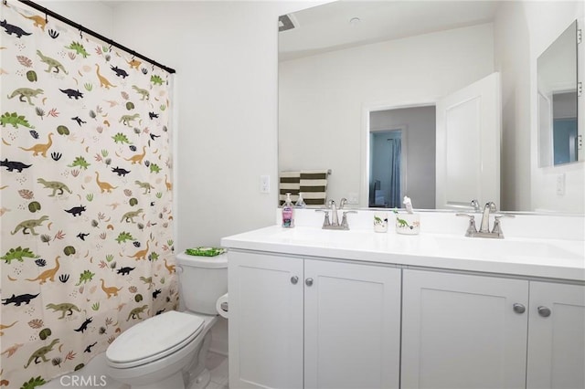 bathroom with a shower with shower curtain, toilet, double vanity, and a sink