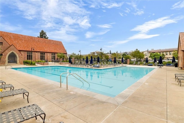 community pool with a patio area