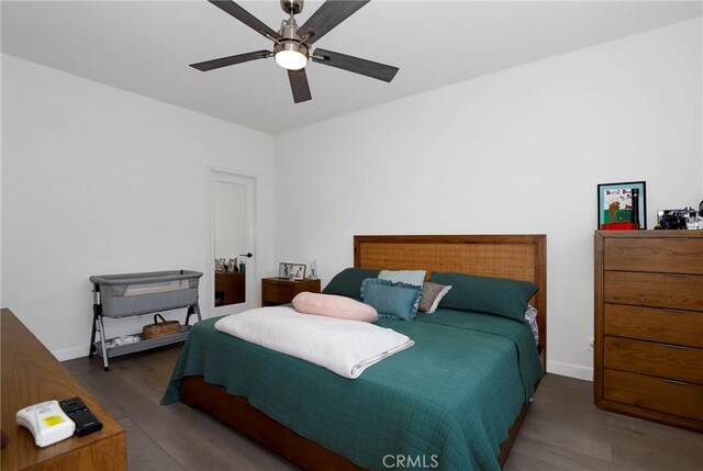 bedroom featuring wood finished floors, ceiling fan, and baseboards