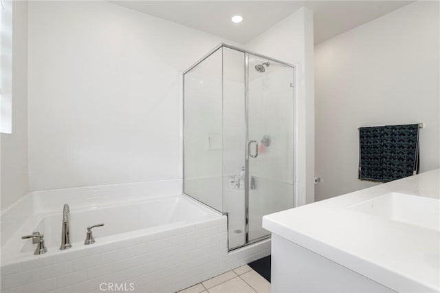 bathroom featuring tile patterned floors, recessed lighting, a bath, and a stall shower