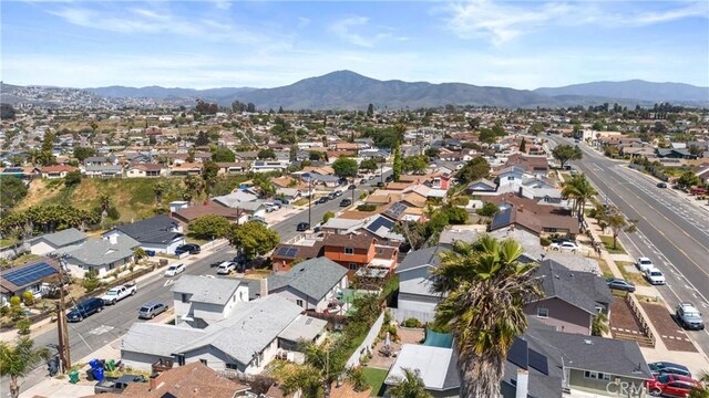 drone / aerial view featuring a residential view and a mountain view