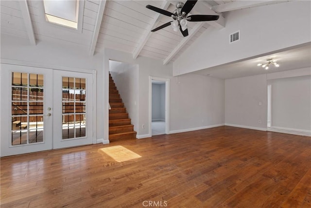 unfurnished living room featuring ceiling fan, french doors, visible vents, lofted ceiling with beams, and stairs