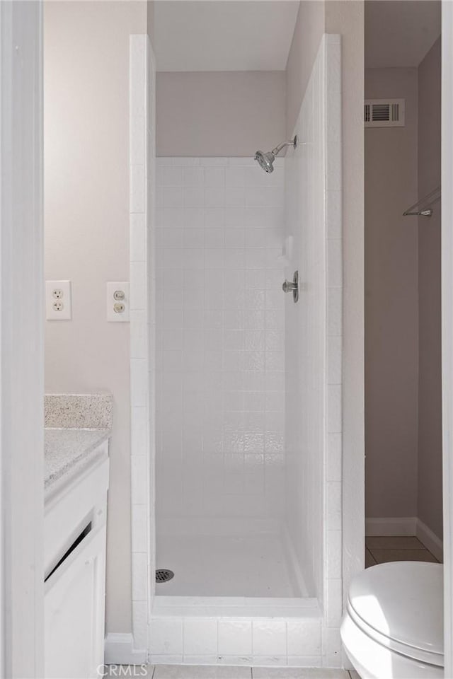 full bathroom featuring vanity, toilet, visible vents, and a stall shower