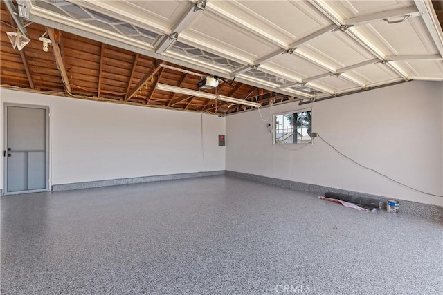 garage with baseboards and a garage door opener