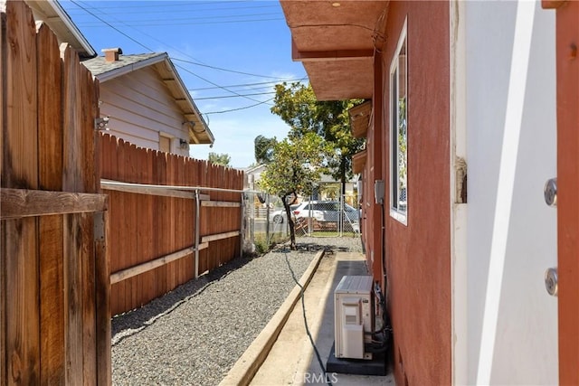 view of side of home with fence and ac unit