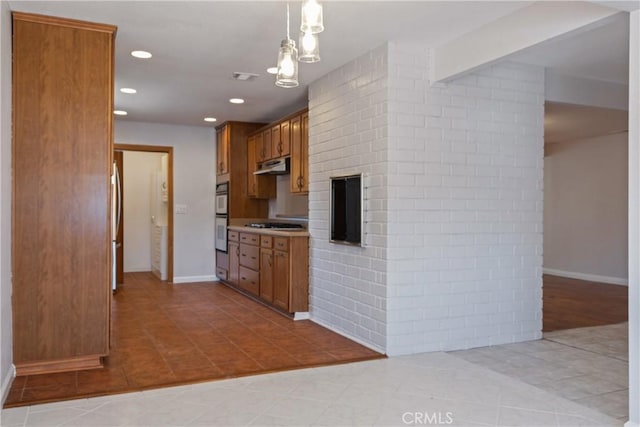 kitchen with under cabinet range hood, brown cabinets, recessed lighting, and light tile patterned floors