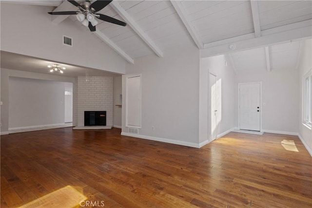 unfurnished living room featuring visible vents, a fireplace, hardwood / wood-style floors, beamed ceiling, and ceiling fan