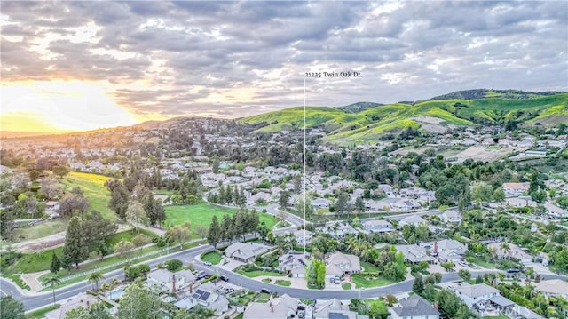 aerial view at dusk featuring a residential view and a mountain view
