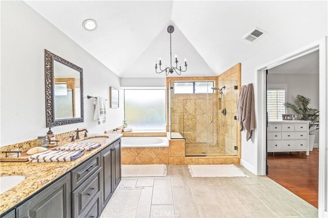 full bathroom with an inviting chandelier, a bath, a sink, visible vents, and a stall shower