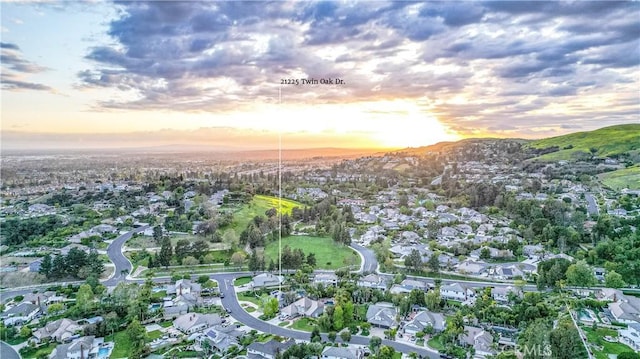 aerial view at dusk featuring a residential view