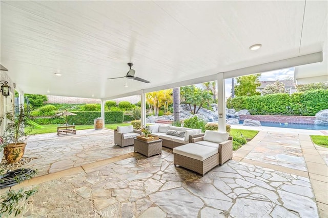 view of patio with an outdoor pool, ceiling fan, and an outdoor living space