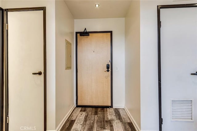 doorway featuring baseboards, visible vents, wood finished floors, and recessed lighting