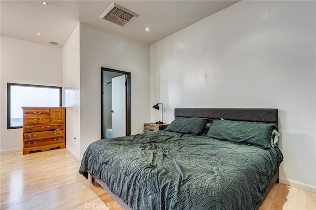 bedroom featuring baseboards, visible vents, wood finished floors, and recessed lighting