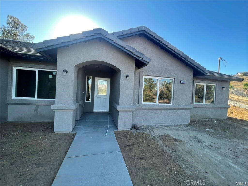 doorway to property with stucco siding