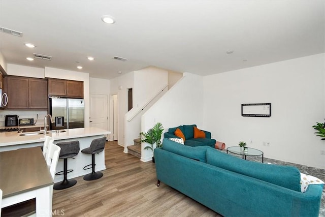 1353 Clary Ct, Upland, CA 91786 - living room with stairs, light wood finished floors, and recessed lighting
